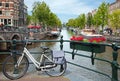 White Bicycle on a Bridge Overlooking a Canal in Amsterdam against Blue Sky