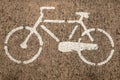 White bicycle painted on asphalt road made of concrete, cement and stones. Concept of healthy, ecological, sport and fun life