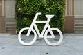 White bicycle sign on asphalt. Bike lane cycle on sidewalk. Royalty Free Stock Photo