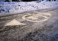 White bicycle symbol on cycle path covered in snow in winter Royalty Free Stock Photo