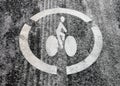 White bicycle symbol on cycle path covered in winter Royalty Free Stock Photo