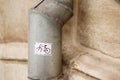 White bicycle symbol sticker on a rain down spout pipe