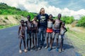 White Big Men Tourist posing near Benna Tribe Young Boys with Traditional Body Painting Royalty Free Stock Photo