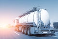 White big modern tanker shipment cargo commercial semi trailer truck moving fast on motorway road city urban suburb Royalty Free Stock Photo