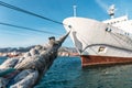 White big ship moored in harbour port, selective focus on mooring rope Royalty Free Stock Photo