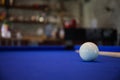 White Billiard ball on blue pool table