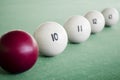 White billiard balls and cue ball for billiards. A row of balls on a pool table
