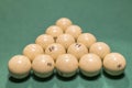 White billiard balls for Russian billiards, in a triangle on the table. Russian billiards balls and cue on the table, the pyramid