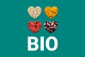 White Bio text on turquoise background and Hearts with cacao nibs, white quinoa grains, dried goji berries and