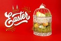 White bird cage with Easter eggs in it on a red background Royalty Free Stock Photo