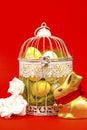 White bird cage with Easter eggs in it on a red background Royalty Free Stock Photo