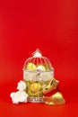 White bird cage with Easter eggs in it on a red background Royalty Free Stock Photo