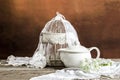 White cage and a tea pot with flowers and decoration on a wooden table Royalty Free Stock Photo