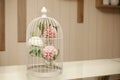 White birdcage with flowers inside