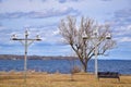 White Birdhouses on Tall Poles Along the Lakeshore