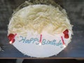 White birthday cake with lit candles Royalty Free Stock Photo