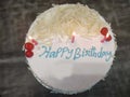 White birthday cake with lit candles Royalty Free Stock Photo