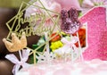 White birthday cake with pink candles as decorations on the table on pink air ballons background. Celebration, festive background