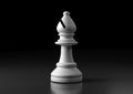 White bishop chess, standing against black background
