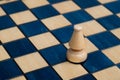 White bishop on wooden chessboard