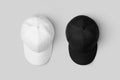 White and black baseball caps mockup, side by side Royalty Free Stock Photo