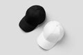 White and black baseball caps mockup, side by side Royalty Free Stock Photo