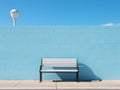 a white and black bench sitting in front of a blue wall