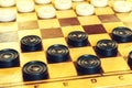 White and black checkers on the Board Royalty Free Stock Photo
