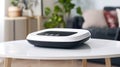 A white and black device sits on a table in a living room Royalty Free Stock Photo