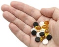 White, black and golden clear pills in your palm Royalty Free Stock Photo