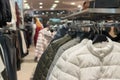 White, black and gray down jackets on the rack, shop