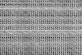 White and black knitted fabric background texture. gray fabric with a pattern. Fragment grey wool carpet, bright wicker dark rug