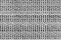 White and black knitted fabric background texture. gray fabric with a pattern. Fragment grey wool carpet, bright wicker dark rug Royalty Free Stock Photo