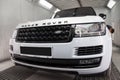 White and black Land Rover Range Rover Autobiography front view in auto service garage waiting for wash and detailing
