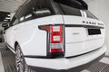White and black Land Rover Range Rover Autobiography rear view in auto service garage waiting for wash and detailing