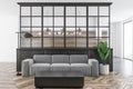 White and black living room, gray sofa, wood floor Royalty Free Stock Photo