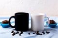 White and black mug mockup with coffee beans and muffins Royalty Free Stock Photo