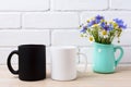 White and black mug mockup with cornflower and daisy Royalty Free Stock Photo