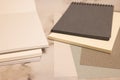 white and black notebook, color sheets on gray background Royalty Free Stock Photo