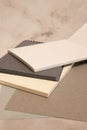 white and black notebook, color sheets on gray background Royalty Free Stock Photo
