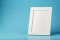 White and black photo frame with empty space on a blue background. Royalty Free Stock Photo