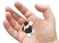 White and black pills in your palm Royalty Free Stock Photo