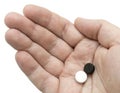 White and black pills in your palm Royalty Free Stock Photo