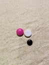 White, black and pink medical pill on a beige ceramic plate. Concept of medicine and pharmacy. Top view. Royalty Free Stock Photo