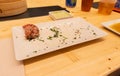 White, black and red pork meat, shrimps and mushroom steamed dumplings on a wooden table in a wooden steamer in an asian