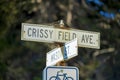 White and black road sign that say Crissy field avenue and mason street with bicycle on post near road in downtown city Royalty Free Stock Photo