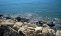 White and black sea rocks on the seaside and glitter shiny water Royalty Free Stock Photo