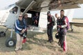 White and black skydivers mounting a X328 Atlas Angel Turbine sp