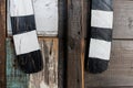 White and black striped wooden decoration on a wall made of wood