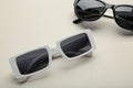 White and black sunglasses on grey background, top view, flat lay, minimalistic concept of summer, vacation Royalty Free Stock Photo